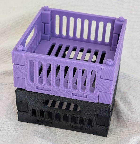 Purple and black earlier flat-pack crate prints stacked together